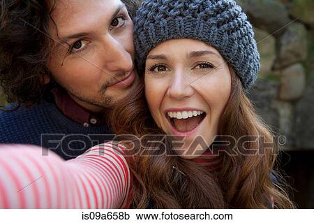 Couple taking picture together outdoors View Large Photo Image Stock Image - Couple taking picture together outdoors. Fotosearch