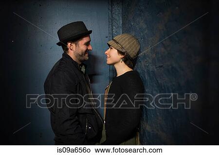 Picture - Couple talking in alleyway. Fotosearch