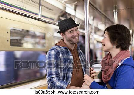Stock Image - Couple talking on urban subway. Fotosearch