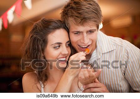 Couple tasting olives in grocery View Large Photo Image Stock Image - Couple tasting olives in grocery. Fotosearch