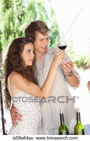 Couple tasting wine in doorway View Large Photo Image Stock Photograph - Couple tasting wine in doorway. Fotosearch