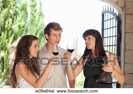 Couple tasting wine in doorway View Large Photo Image Stock Photograph - Couple tasting wine in doorway. Fotosearch