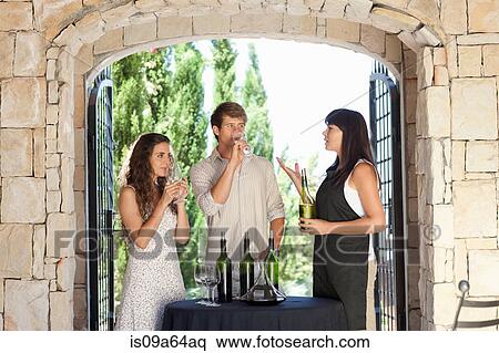 Couple tasting wine in doorway View Large Photo Image Stock Photography - Couple tasting wine in doorway. Fotosearch