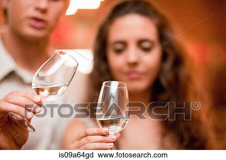 Stock Image - Couple tasting wine in grocery. Fotosearch