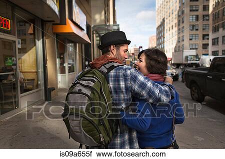 Stock Image - Couple walking on city street. Fotosearch