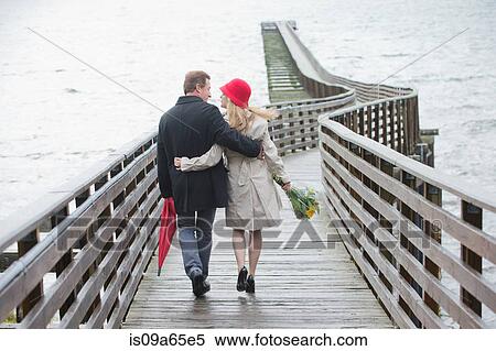 Couple walking on wooden dock View Large Photo Image Stock Photography - Couple walking on wooden dock. Fotosearch