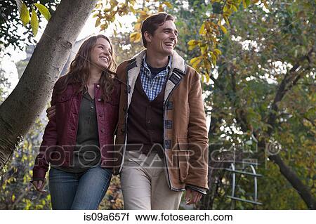 Couple walking together outdoors View Large Photo Image Stock Image - Couple walking together outdoors. Fotosearch