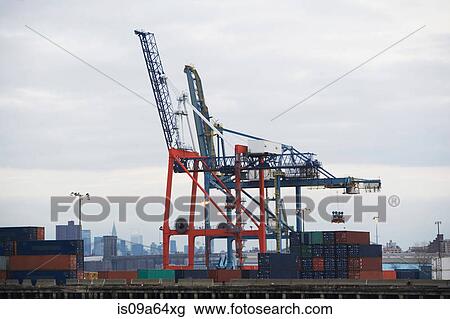 Stock Image - Crane and containers on loading dock. Fotosearch