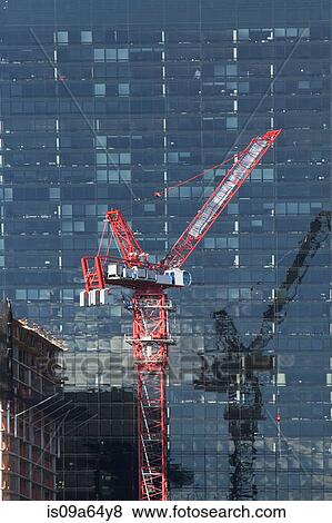 Stock Photo - Crane by urban skyscraper. Fotosearch
