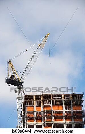 Crane over building in construction View Large Photo Image Picture - Crane over building in construction. Fotosearch