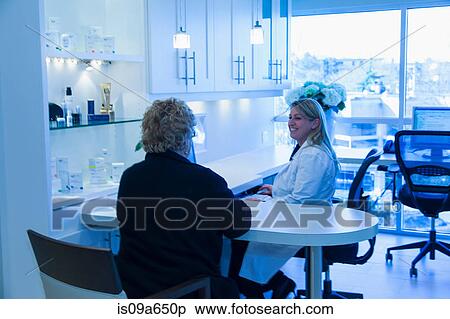 Doctor and patient talking in office View Large Photo Image Stock Photography - Doctor and patient talking in office. Fotosearch