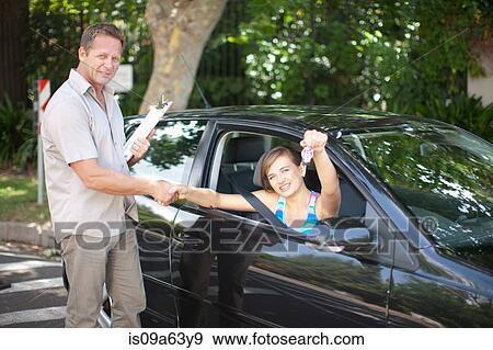 Driving instructor congratulating student View Large Photo Image Stock Photo - Driving instructor congratulating student. Fotosearch