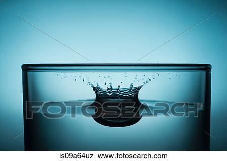 Drop splashing in glass of water View Large Photo Image Stock Photo - Drop splashing in glass of water. Fotosearch