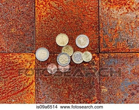 Picture - Euro coins on brick floor. Fotosearch