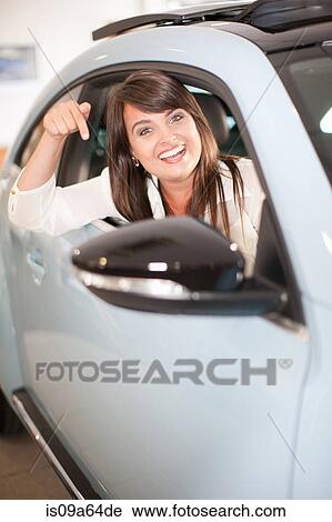Excited woman pointing to new car View Large Photo Image Stock Image - Excited woman pointing to new car. Fotosearch