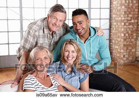 Stock Photo - Family relaxing together on sofa. Fotosearch