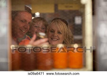 Stock Image - Family shopping for jam in grocery. Fotosearch