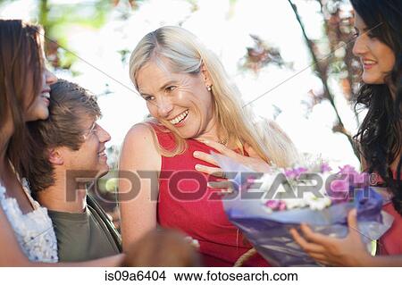 Family smiling at mother View Large Photo Image Picture - Family smiling at mother. Fotosearch