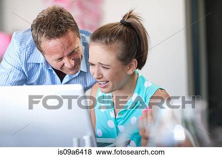 Father and daughter using laptop View Large Photo Image Stock Photo - Father and daughter using laptop. Fotosearch