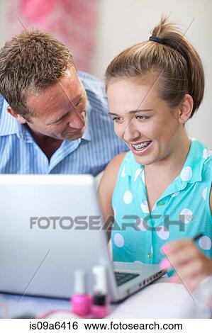 Father and daughter using laptop View Large Photo Image Stock Photograph - Father and daughter using laptop. Fotosearch