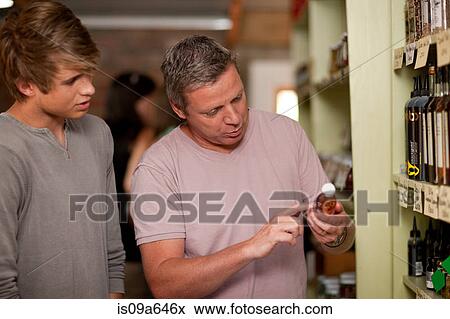 Stock Photo - Father and son shopping for wine. Fotosearch