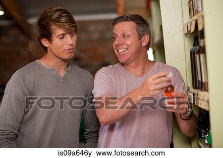 Stock Photo - Father and son shopping for wine. Fotosearch