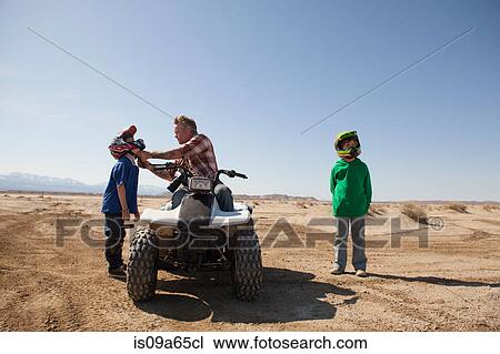 Father and sons on four-wheeler View Large Photo Image Stock Image - Father and sons on four-wheeler. Fotosearch