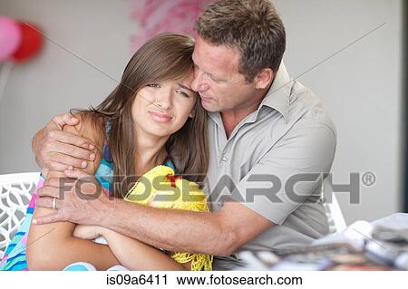 Father comforting teenage daughter View Large Photo Image Stock Image - Father comforting teenage daughter. Fotosearch