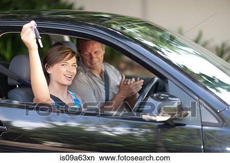 Picture - Father giving teenage daughter new car. Fotosearch