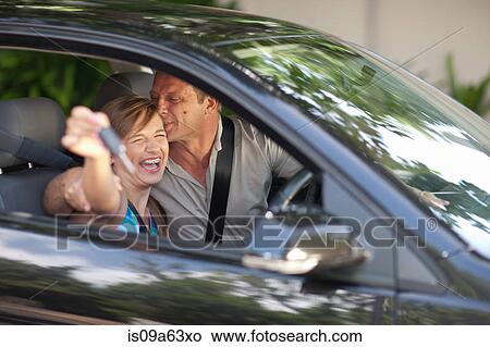 Picture - Father giving teenage daughter new car. Fotosearch