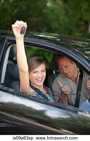 Stock Photography - Father giving teenage daughter new car. Fotosearch