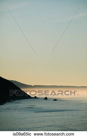 Stock Image - Fog rolling over ocean. Fotosearch