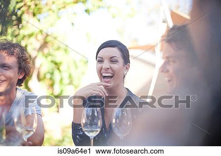Friends having drinks at table outdoors View Large Photo Image Stock Image - Friends having drinks at table outdoors. Fotosearch