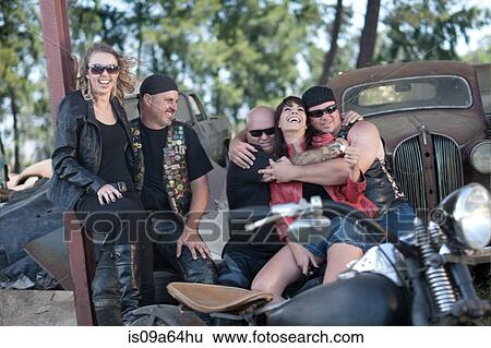 Stock Photograph - Friends relaxing by vintage cars. Fotosearch