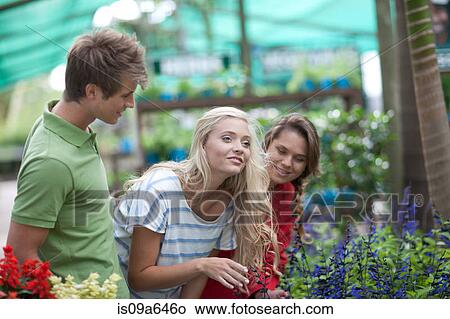 Picture - Friends shopping for plants in nursery. Fotosearch