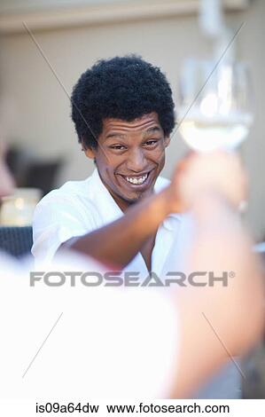 Stock Photo - Friends toasting each other outdoors. Fotosearch