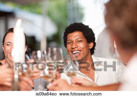 Friends toasting in restaurant View Large Photo Image Picture - Friends toasting in restaurant. Fotosearch
