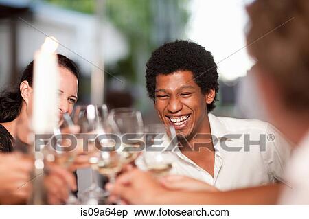 Stock Photography - Friends toasting in restaurant. Fotosearch