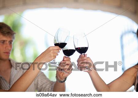 Stock Photo - Friends toasting with wine outdoors. Fotosearch