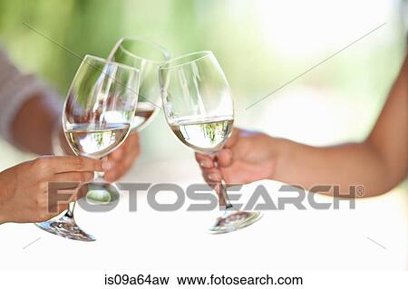 Friends toasting with wine outdoors View Large Photo Image Stock Photo - Friends toasting with wine outdoors. Fotosearch