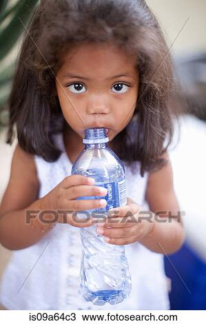 Girl drinking out of water bottle View Large Photo Image Stock Image - Girl drinking out of water bottle. Fotosearch