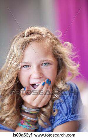 Stock Image - Girl gasping with hand over mouth. Fotosearch
