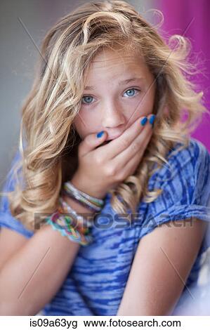 Stock Image - Girl gasping with hand over mouth. Fotosearch