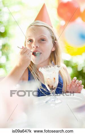 Girl having ice cream sundae at party View Large Photo Image Stock Image - Girl having ice cream sundae at party. Fotosearch