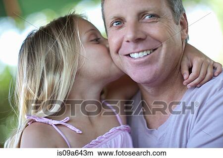 Picture - Girl kissing father outdoors. Fotosearch