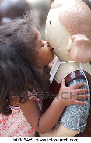 Stock Photo - Girl kissing statue outdoors. Fotosearch
