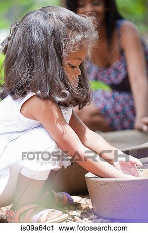 Girl playing in planter View Large Photo Image Stock Image - Girl playing in planter. Fotosearch