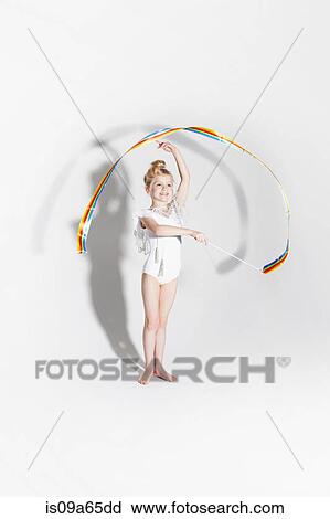 Stock Image - Girl playing with ribbon streamers. Fotosearch