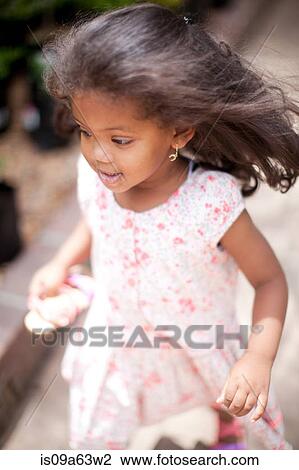 Stock Image - Girl running outdoors. Fotosearch