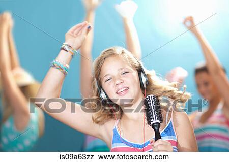 Stock Photo - Girl singing into hairbrush. Fotosearch